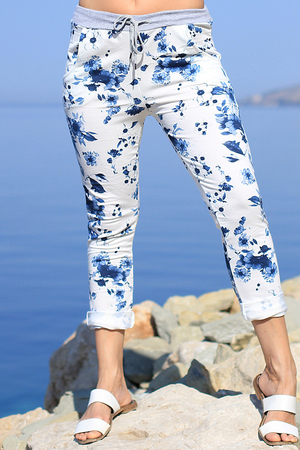 Bílé bavlněné dámské kalhoty s romantickým motivem modrých květin. V pase je šedý úplet s tkaničkou na stažení